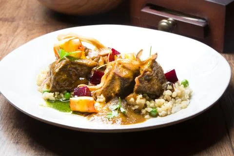 A plate of calf cheeks on a table Stock Photos