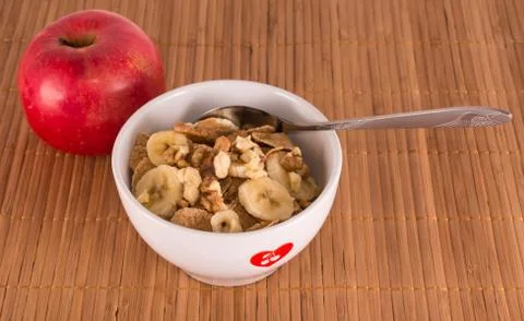 A plate of cereal, bananas and walnuts Stock Photos