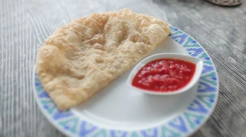 On the plate is cheburek with sauce. Stock Footage 65814345