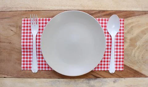 The plate on checkered tablecloth Foto stock