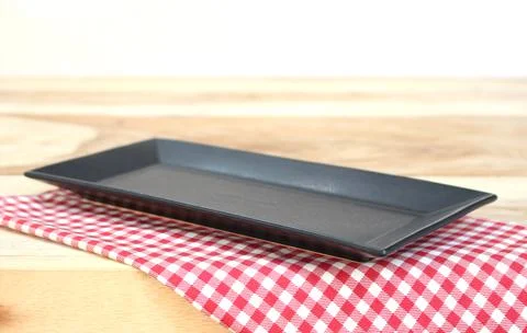 The plate on checkered tablecloth Stock Photos