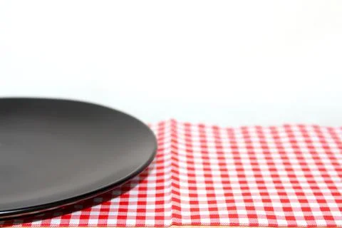 The plate on checkered tablecloth Stock Photos
