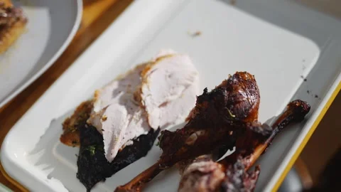 A plate of chicken with a piece missing Stock Footage 295370778