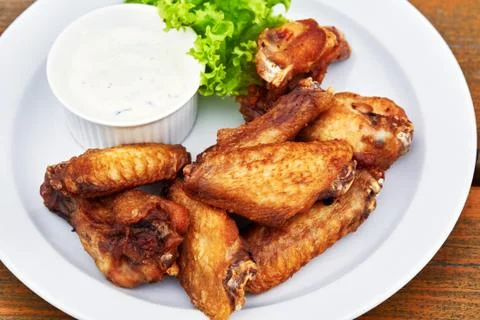 A plate of chicken wings on a table Stock Photos