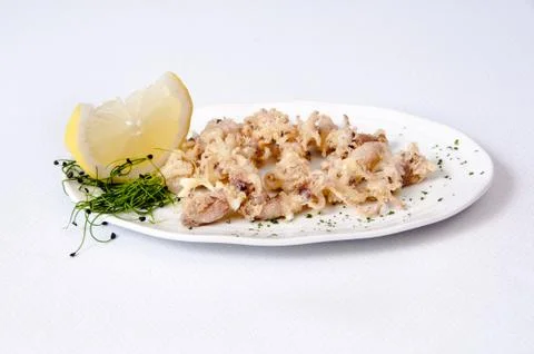 A plate of chipirones on a white background Stock Photos