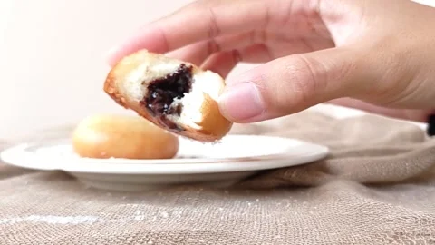 A plate of chocolate buns on a brown table Stock Footage 146251539