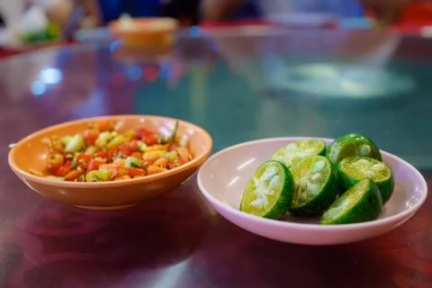 Plate of Chopped Chilli and Plate of Cut Limes Stock Photos