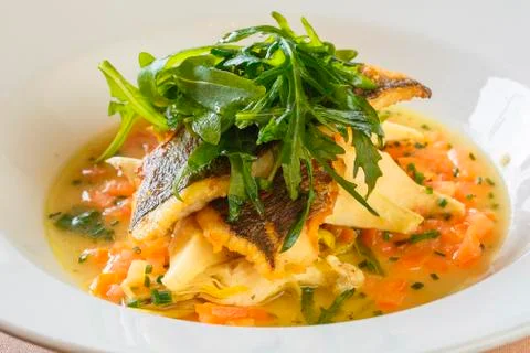 Plate of Cod or Pollack Fish Fillet Stewed in Tomato and Thyme Sauce Garnishe Stock Photos