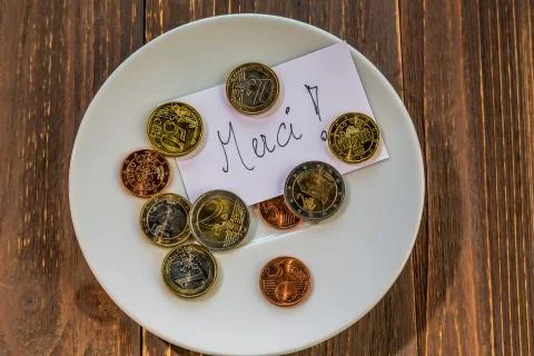 Plate with coins Stock Photos