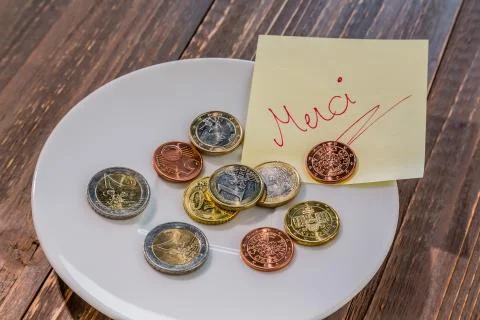 Plate with coins Stock Photos