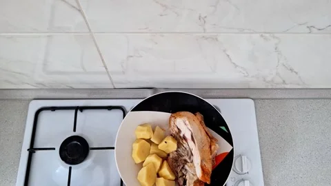 Plate of Cooked Meat and Potatoes on Kitchen Gas Stove Stock Footage 341459246