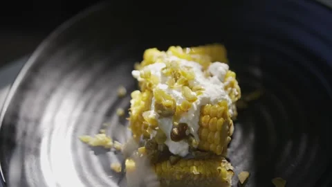 A plate of corn with a white sauce on top Stock Footage 301630081