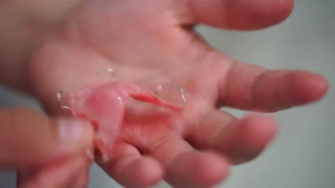 A plate for correcting the bite in children in the hands of a child close-up Stock Footage 307288854