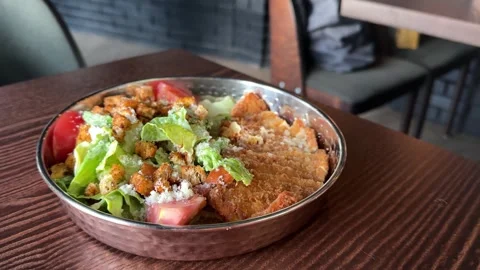 Plate of crispy fried chicken with vegetable salad and a fork. Ideal for comfort Stock Footage 313634362