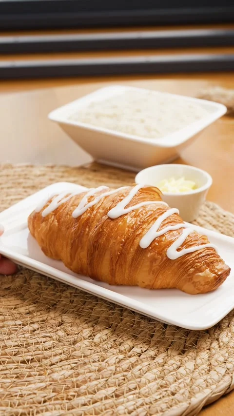 A plate with a croissant was placed on the table Stock Footage 261250441