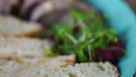 Plate with croutons, meat, herbs on the table of the restaurant. Change focus Stock Footage 141323435