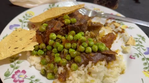 A plate of Curry rice and meat with gravy and green peas. Stock Footage 342754309