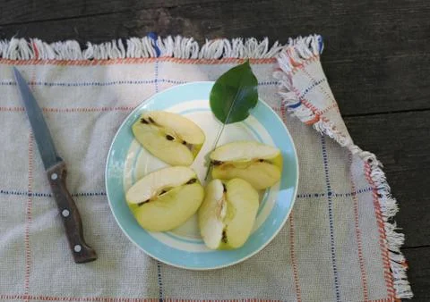 Plate with cut apples on tablecloath Stock Photos