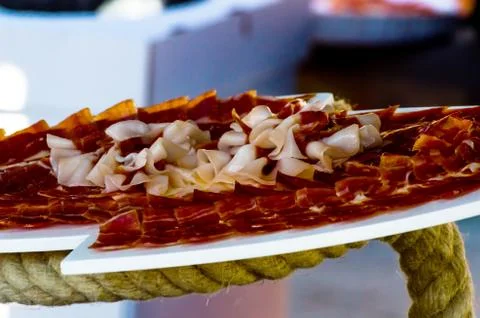 Plate with cut slices of jamon serrano, traditional Spanish ham Stock Photos