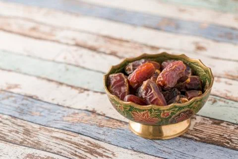 Plate of date on turquoise table side view Stock Photos