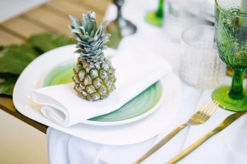 Plate decorated with a pineapple and decor, green and white colour Stock Photos