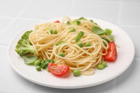 Plate of delicious pasta primavera on white table, closeup Stock Photos