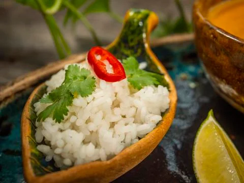 A plate of delicious pumpkin soup, a serving of rice with herbs and a slice o Foto stock