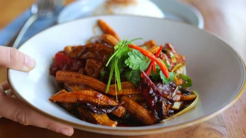 A plate with a delicious vegetable dish is placed on the table. Vegetarian Stock Footage 197904049