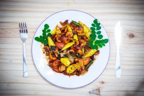 Plate of deviled prawns top view with fork and knife Stock Photos