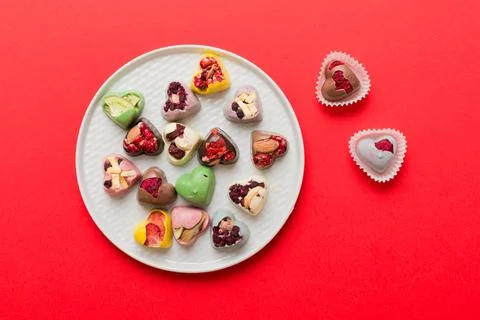 Plate with different chocolate on colored background. Assortment of fine ch.. Stock Photos