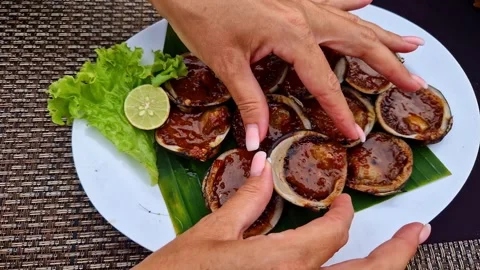 On the plate is dinner prepared from baked shellfish with vegetables and herbs Stock Footage 262963551