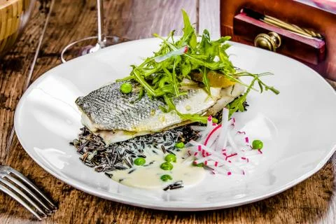 A plate of dorado on a table Foto stock