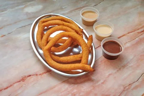 A plate of doughnuts with three different sauces Stock-Fotos