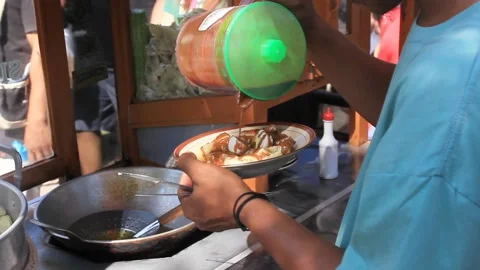 A plate of dumplings smeared with peanut sauce by the seller Stock Footage 287754178