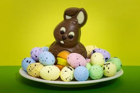 A plate of Easter eggs and a chocolate bunny Stock Photos