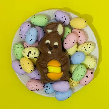 A plate of Easter eggs and a chocolate bunny Stock Photos