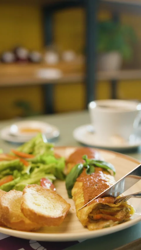 Plate with Egg Omelette Roll, Fresh Salad and Bread Stock Footage 321936121