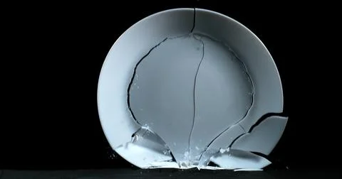 Plate falling and exploding on Black Background Foto stock