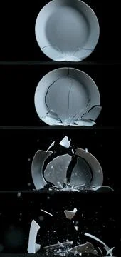 Plate falling and exploding on Black Background Stock Photos
