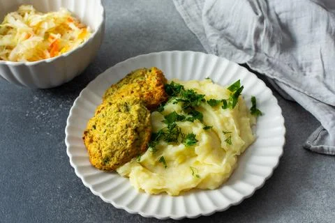 This plate features mashed potatoes, two turkey meatballs, and a side of ferm Stock Photos