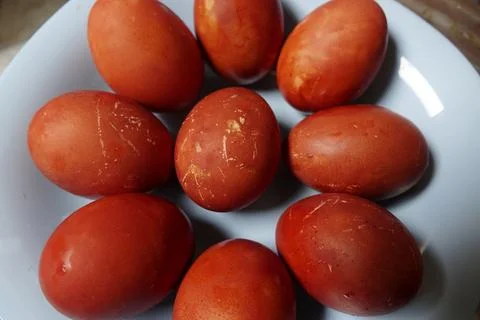 Plate is filled with numerous red Easter eggs with natural red-brown color .. Stock Photos