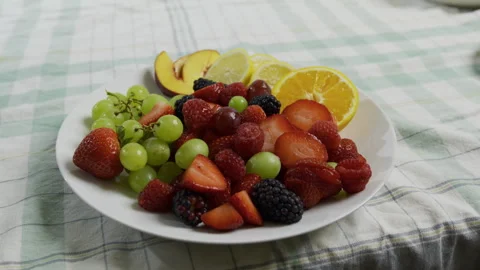 Plate filled with various, colorful fruit - tracking, medium shot Stock Footage 341026706