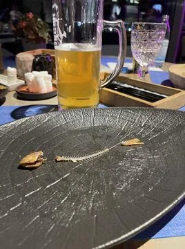 Plate with fish bones red mullet and beer Stock Photos