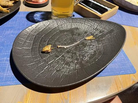 Plate with fish bones red mullet Stock Photos