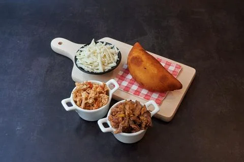 A plate of food with a corn roll and three bowls of food Stock Photos