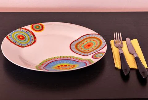 A plate, a fork and a knife Stock Photos