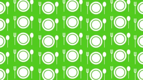 A plate, fork, and spoon on a green background, dynamic background. Stock Footage 345226903