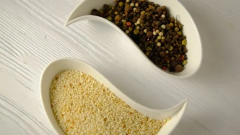 Plate in the form of drops. Dizzy. Yin yang. Sesame and pepper. Spices. White bo Stock Footage 147624946