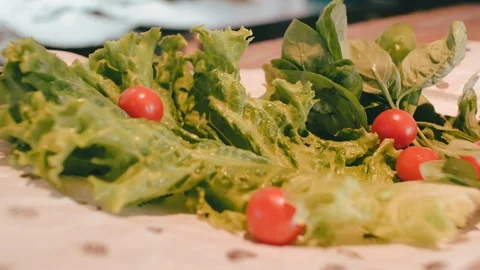 Plate with fresh lettuce, cherry tomatoes and basil. fresh vegetables on plates Stock Footage 115634033