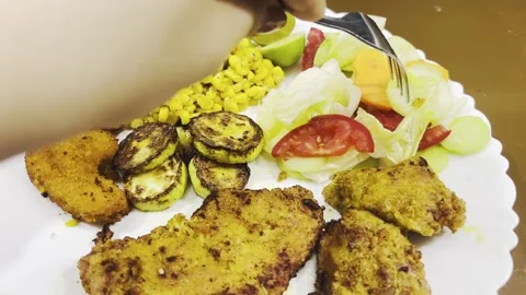 Plate of fried chicken cutlets with salad and grilled zucchini Stock Footage 345144547